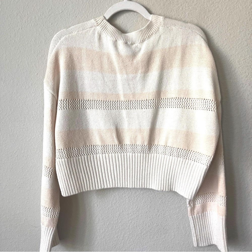 wide, bell-sleeved ivory and nude stripe cable knit crewneck sweater